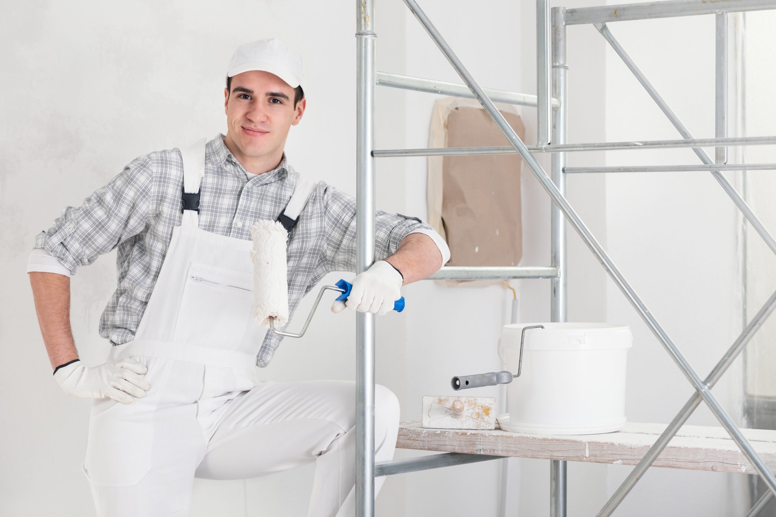 Confident,Relaxed,Young,Painter,At,Work,Leaning,On,Mobile,Interior