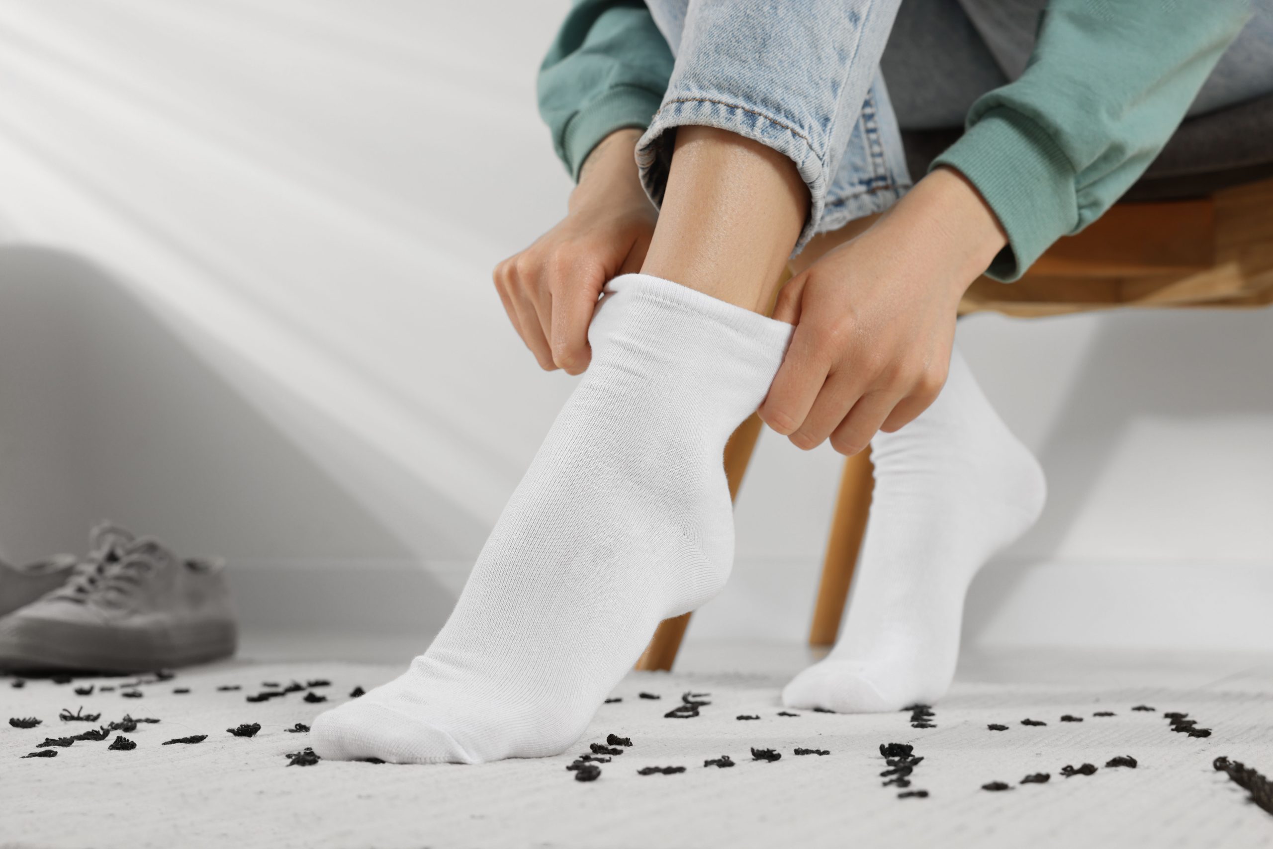 Woman,Putting,On,White,Socks,At,Home,,Closeup